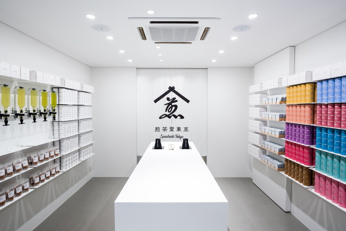 銀座の煎茶堂東京 店内。白い什器と、壁一面に並ぶ色とりどりの茶缶