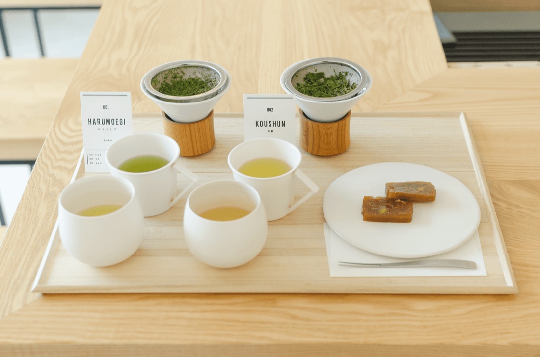 木のトレーに並ぶ二煎分の茶器と茶葉、和菓子